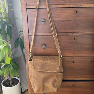 Roots cross body bucket style with flap